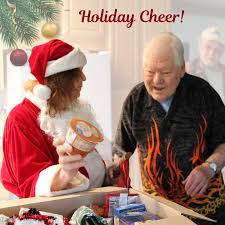 Dr. Jayna dressed as Santa delivering food to a Citrus Heights senior with Meals on Wheels